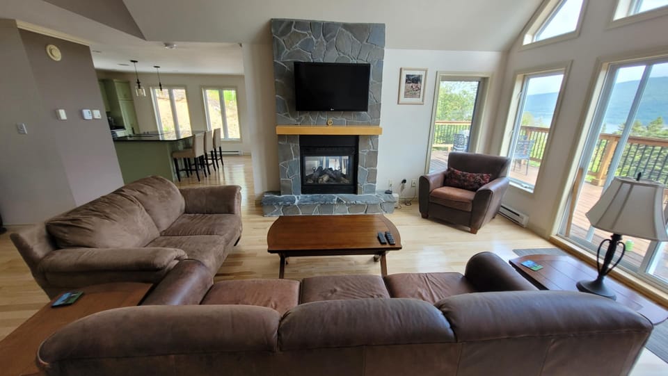 Comfy Living Room complete with propane fireplace, TV and views of the valley.