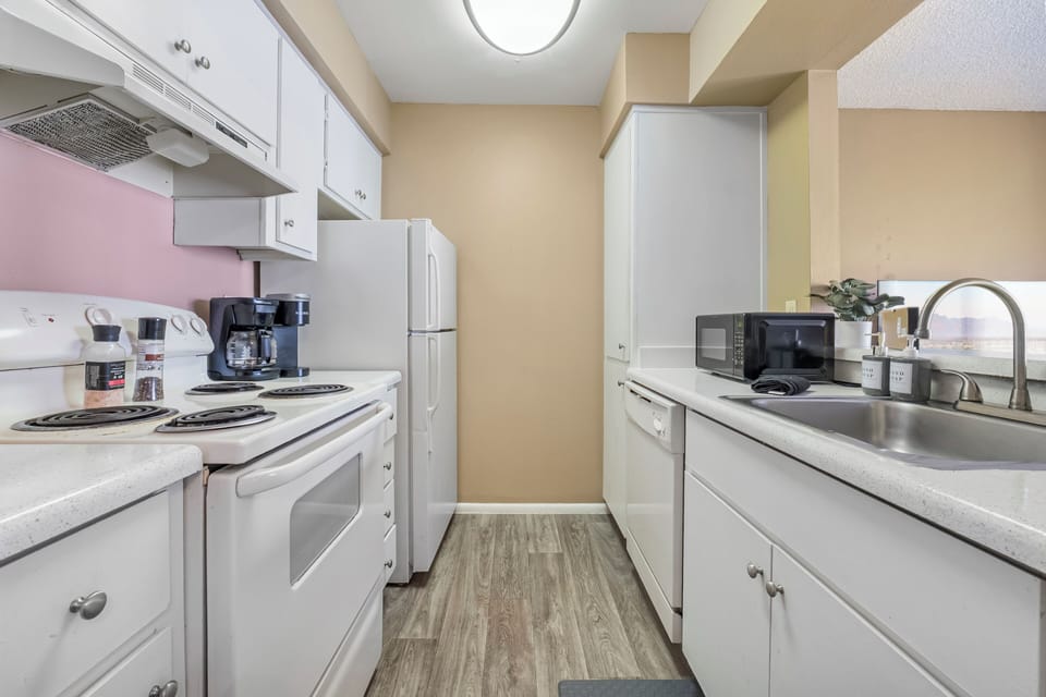 Gallery kitchen with window opening for ease of entertainment. 