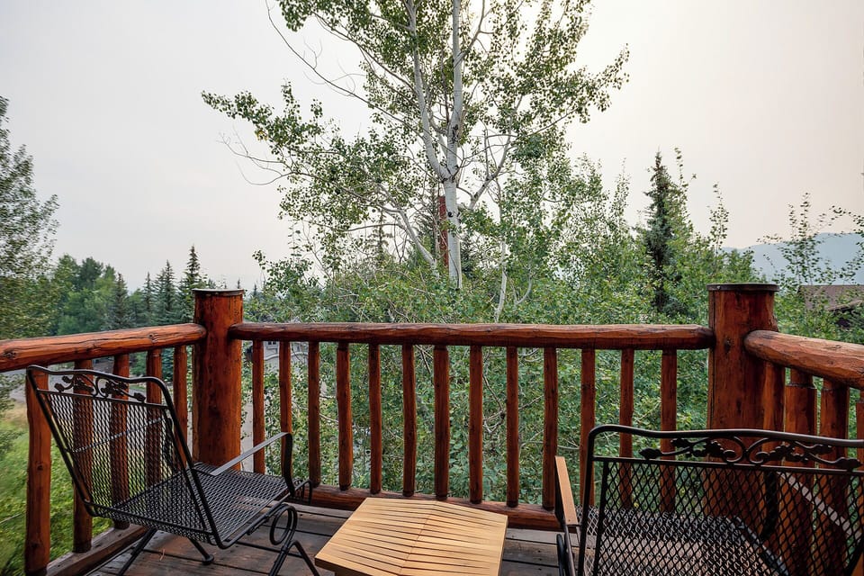 Relax on your private deck overlooking peaceful woods, where morning coffee tastes better surrounded by towering trees and tranquil wilderness.