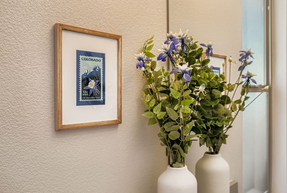 Fresh flowers and thoughtful artwork create a welcoming atmosphere in your cozy retreat.