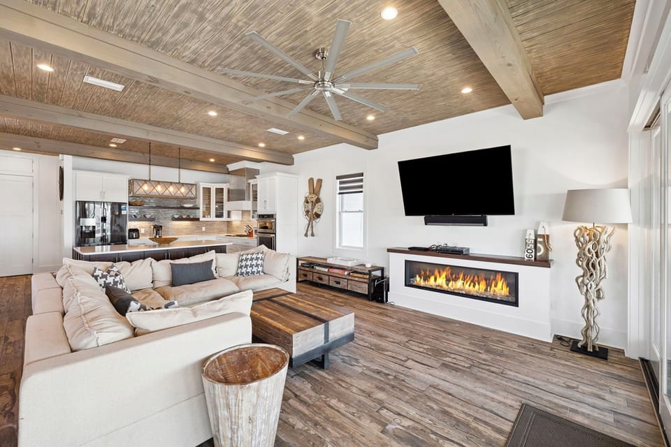 Relax in this stunning open-concept living space where rustic wood beams meet modern comfort. Cozy up by your crackling fireplace while enjoying mountain views.