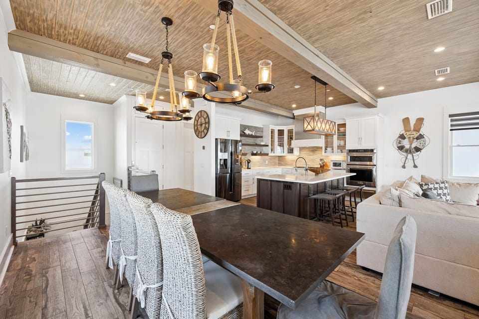 Gather around this stunning open-concept space where rustic charm meets modern comfort—your perfect backdrop for memorable meals together.