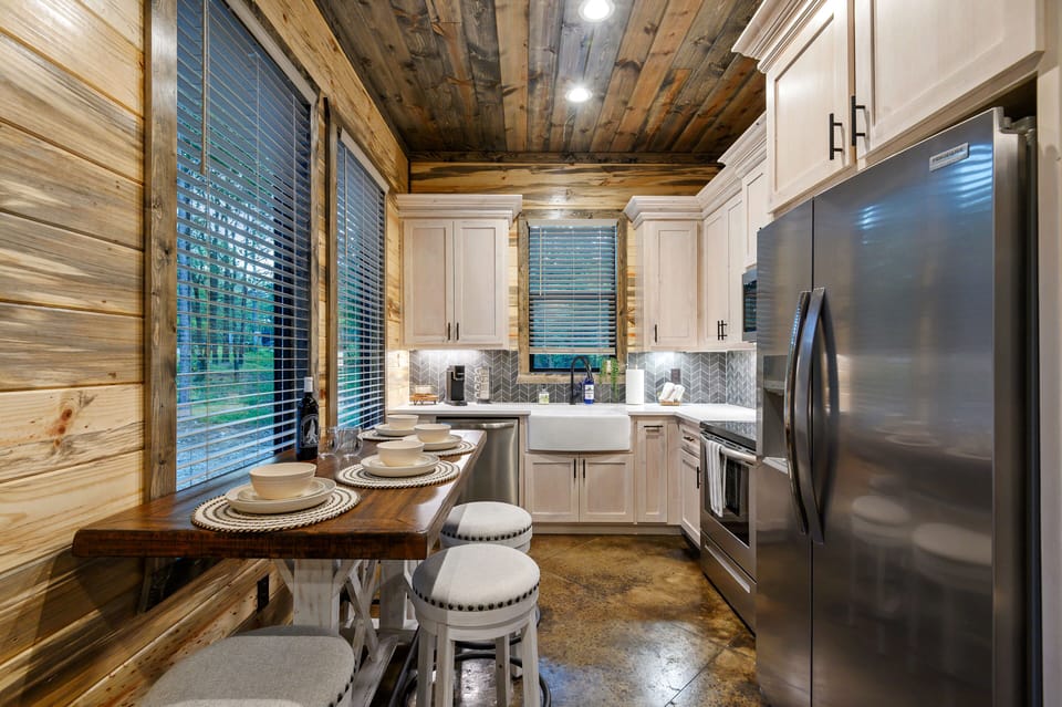 Modern rustic kitchen with wood accents and cozy dining island.