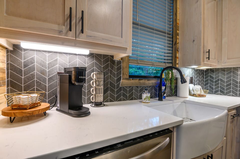 Stylish wood-accented cabin kitchen with coffee bar and farmhouse sink.