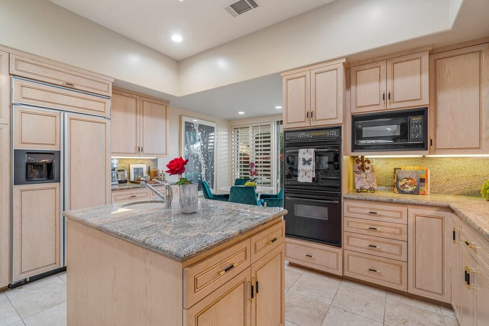 Chef’s Kitchen – Granite counters and custom cabinetry with premium appliances.