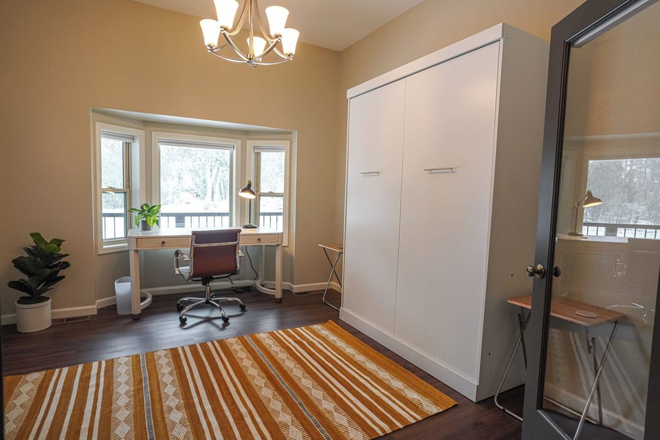 Features a queen memory foam Murphy bed with direct access to the front porch.