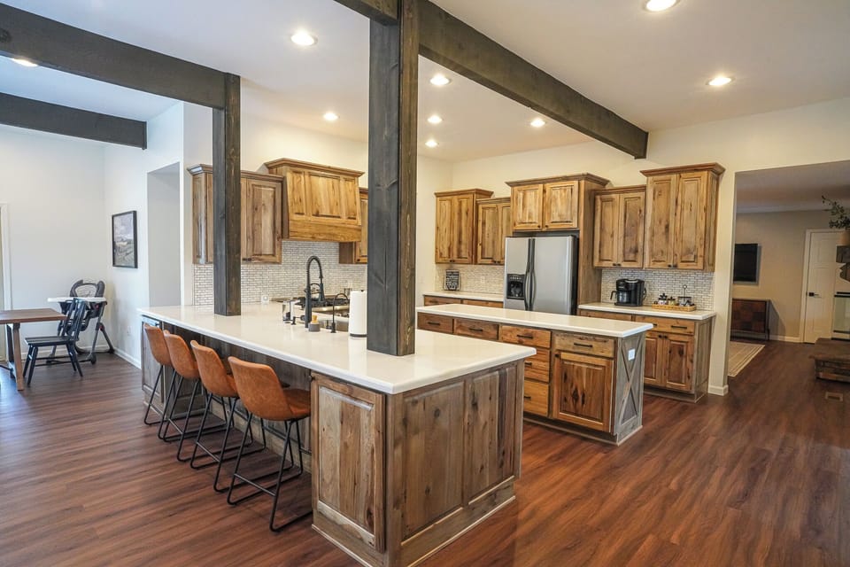 This kitchen features a spacious island with beautiful custom wood cabinetry. 