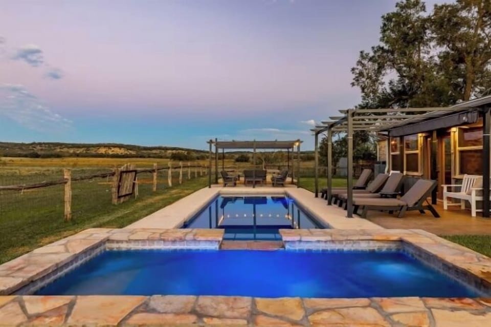 Relax in the pool or spa in the backyard of the main farmhouse