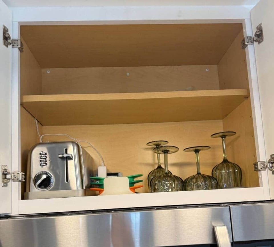 This shelf is part breakfast station, part happy hour prep. Toast your bagel, grab an outdoor plastic wine glass, or chop up an apple with those colorful apple cutters. 