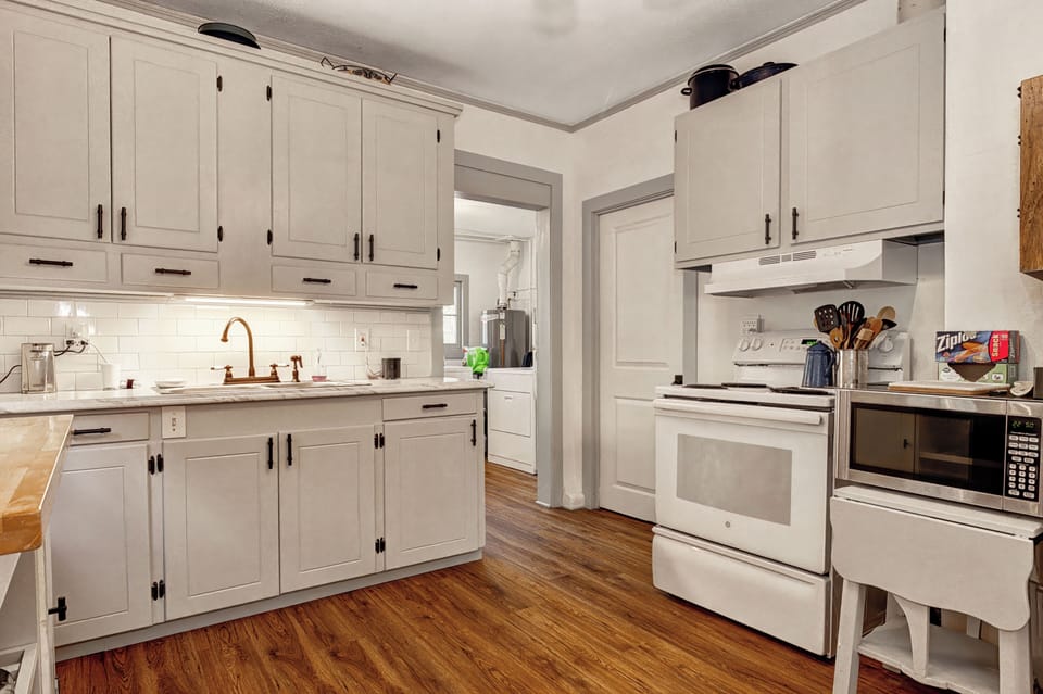 Microwave, stove, oven, coffee maker, pots and pans, dishes, cooking utensils