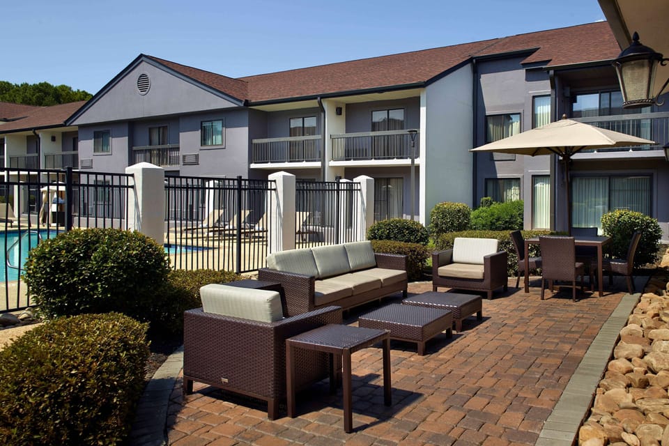 Gather outdoors on comfy seating steps from the pool.