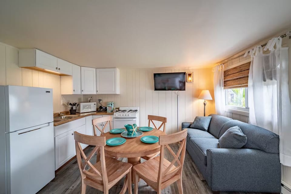 Gather for easy meals beside the cozy sofa and warm light.