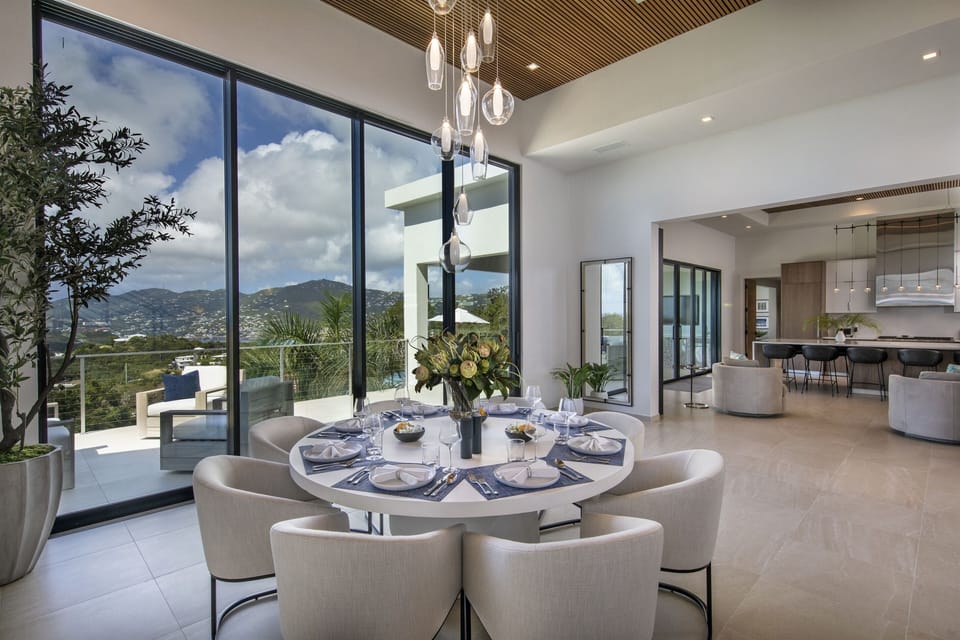 Dining table with views of pool deck and kitchen