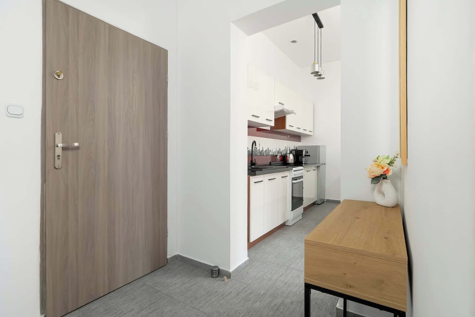 A hallway with wooden doors leading to different rooms. The simple decor emphasizes functionality.