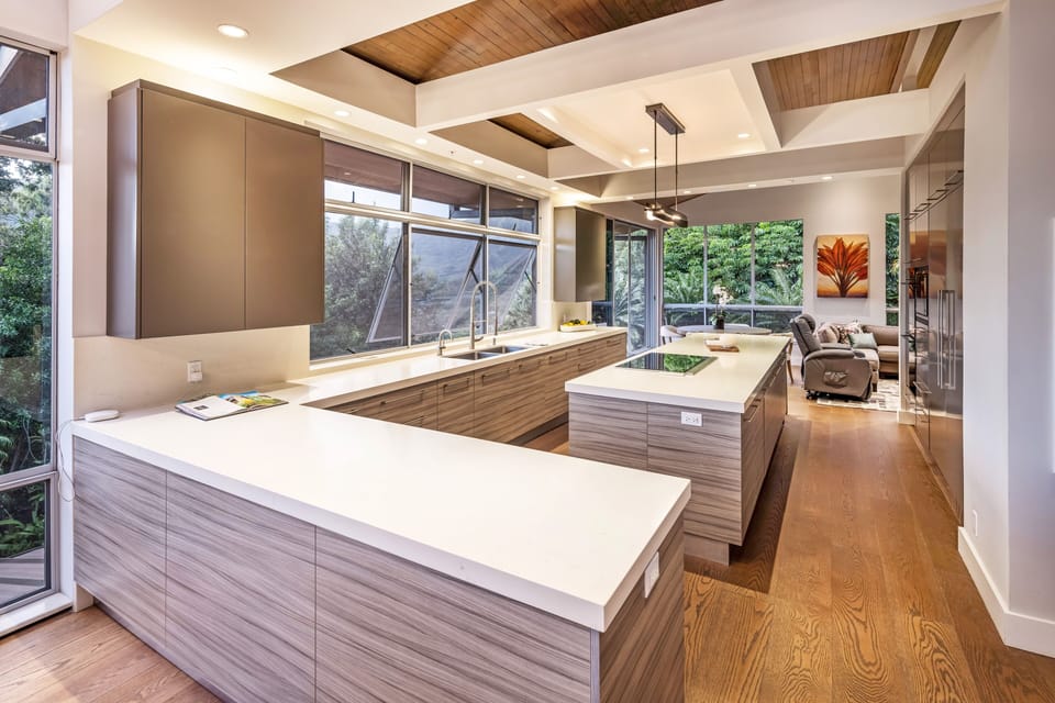 Sleek, modern kitchen with high-end finishes and floor-to-ceiling windows bringing the outdoors in.