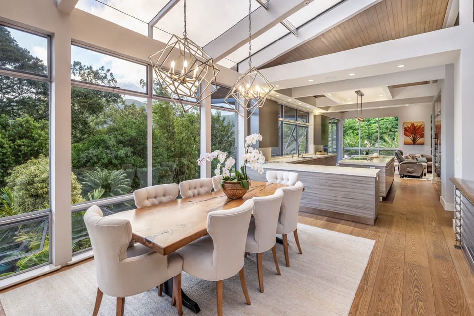 Bright dining space with glass ceiling and lush treetop views—dine in the heart of the rainforest.