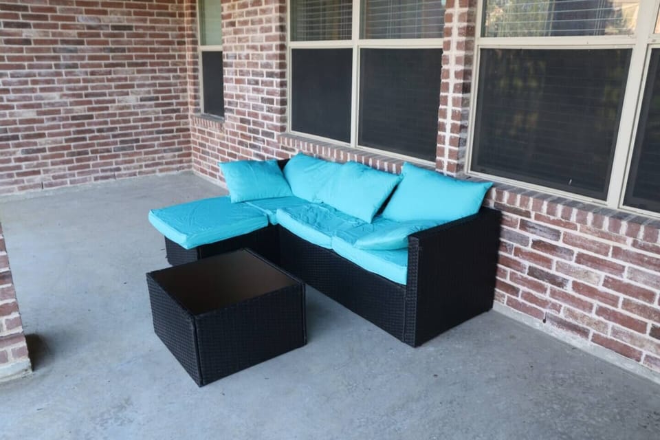 Relax on the outdoor patio with comfortable seating, perfect for unwinding in the fresh air after a day exploring nearby Wylie attractions or enjoying family time.