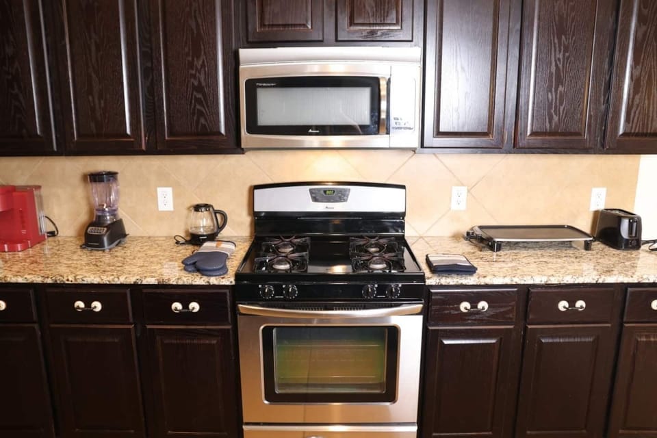 Fully equipped kitchen with modern appliances and ample counter space, ready for preparing home-cooked meals. Close to grocery stores like Walmart and Kroger for all your shopping needs.