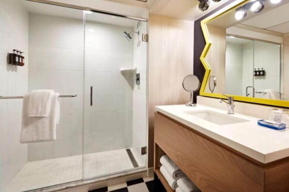 Rinse off in a sleek glass shower and bright vanity.