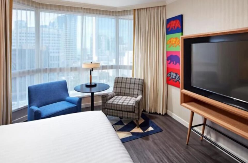Unit with a King bed and a flat-screen TV