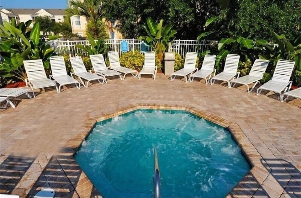 Rejuvenate in the peaceful hot tub surrounded by lush greenery and ample seating.