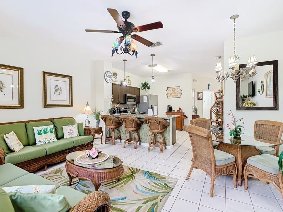 Spacious living and dining area with tropical decor and plenty of light.