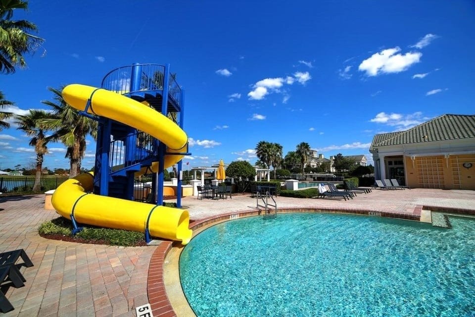 Community pool with thrilling water slides and a sunny lounging area.