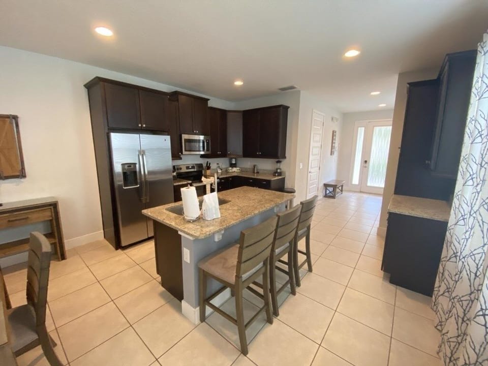 Open-concept kitchen with modern appliances and a large island.