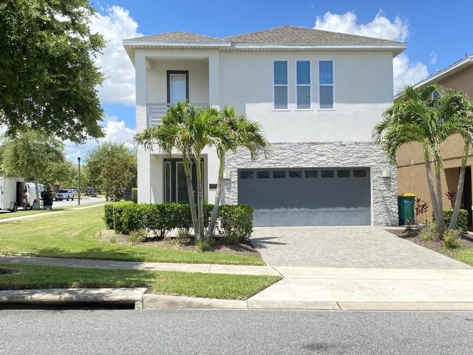 Modern two-story home with lush landscaping and plenty of curb appeal.
