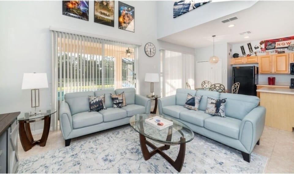 Open-concept living area with beautiful decor and large windows overlooking the backyard.