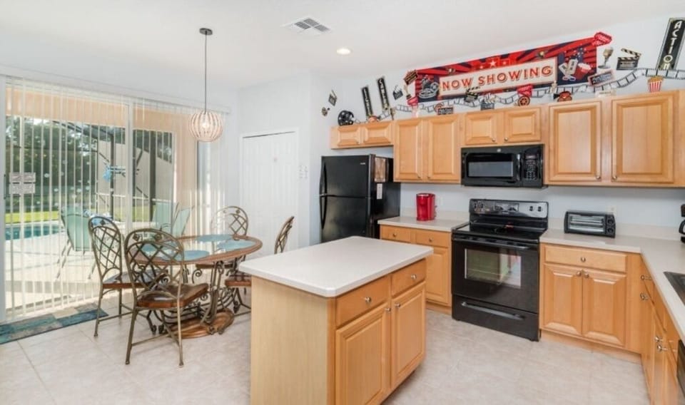 Fully equipped kitchen with modern appliances and a cozy breakfast nook.
