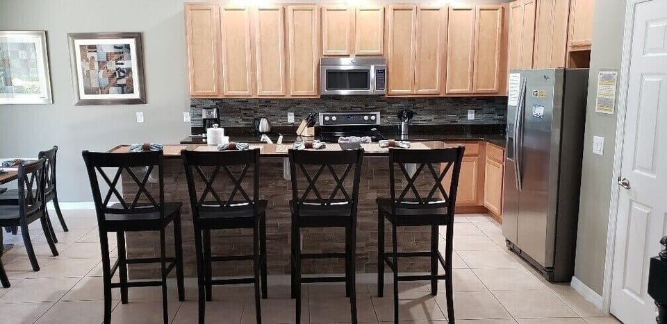 Enjoy casual meals or morning coffee at the inviting breakfast bar with comfortable seating.