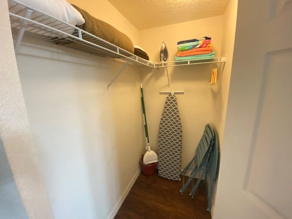 Walk-in closet with plenty of storage and an iron for your stay.