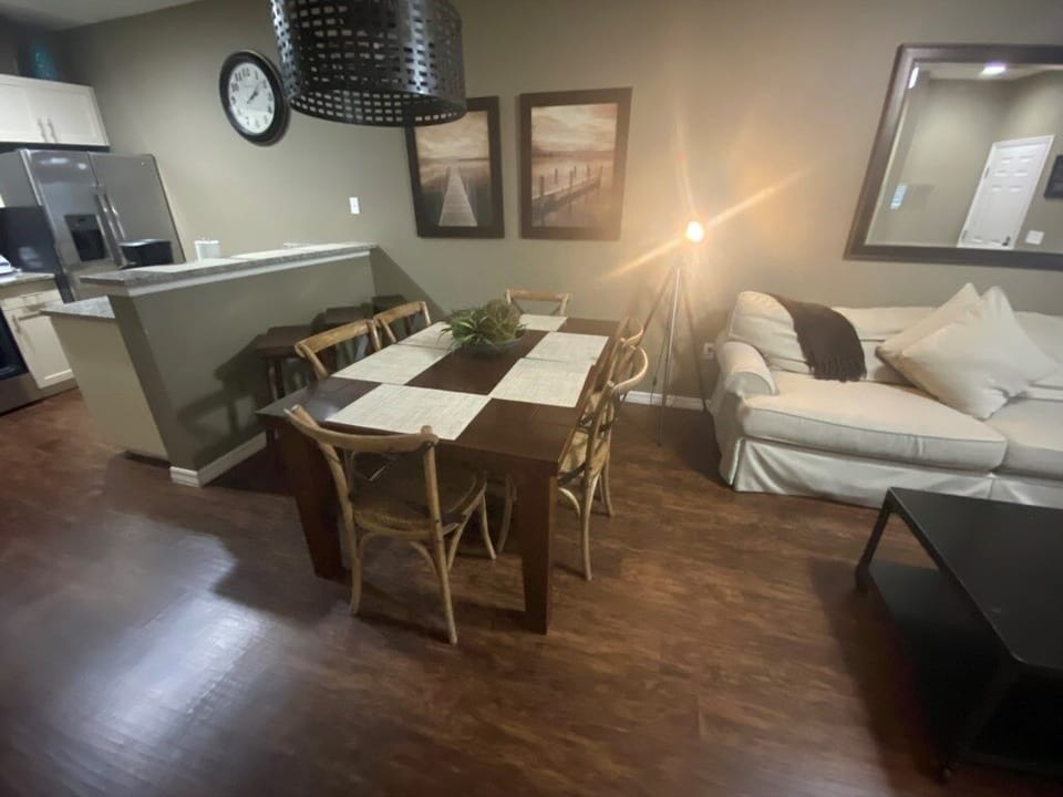 Contemporary dining room ambiance with chic lighting and wooden flooring.