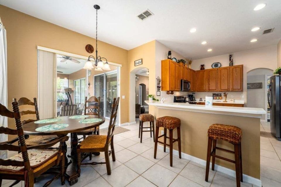 KITCHEN: 3-Seat Breakfast Bar and Eat-In-Kitchen with 4-Seat Dining Table,  Direct Access to Pool/Patio Area