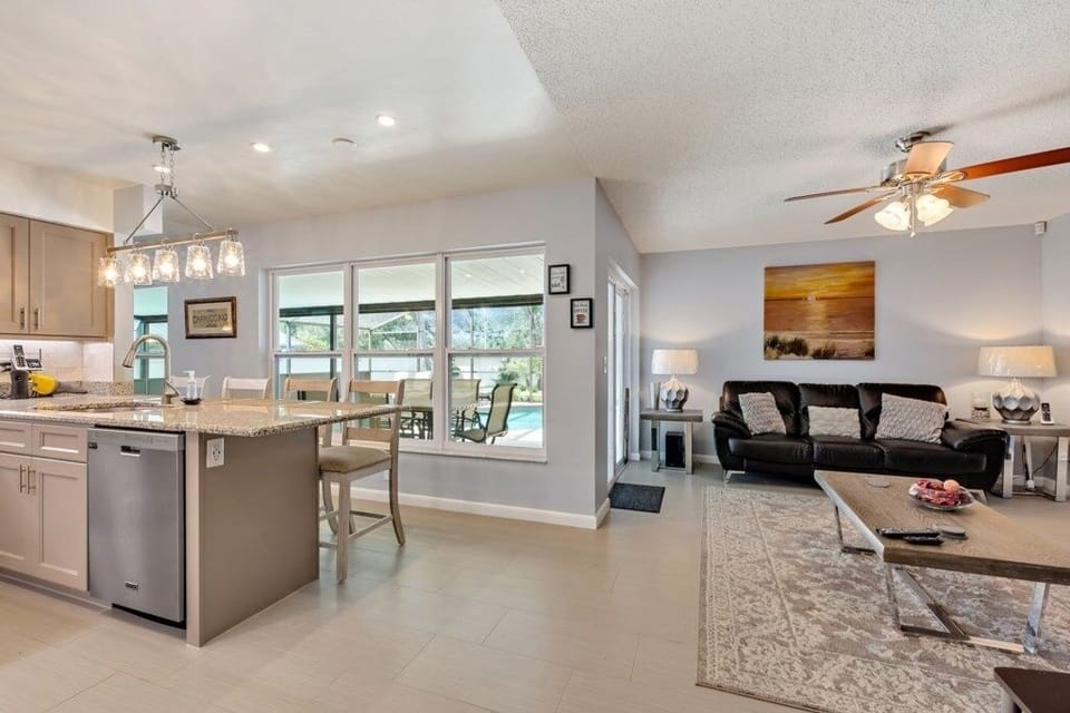 Open kitchen and dining area with large windows offering natural light and scenic views.
