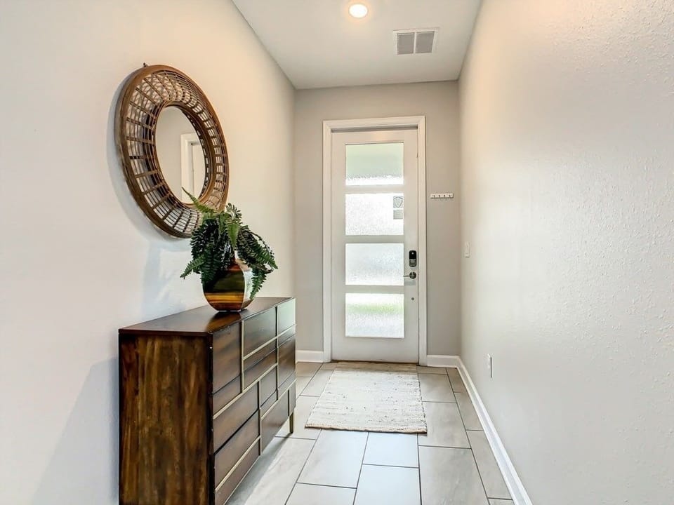 Stylish entryway with warm decor and natural light to greet you.