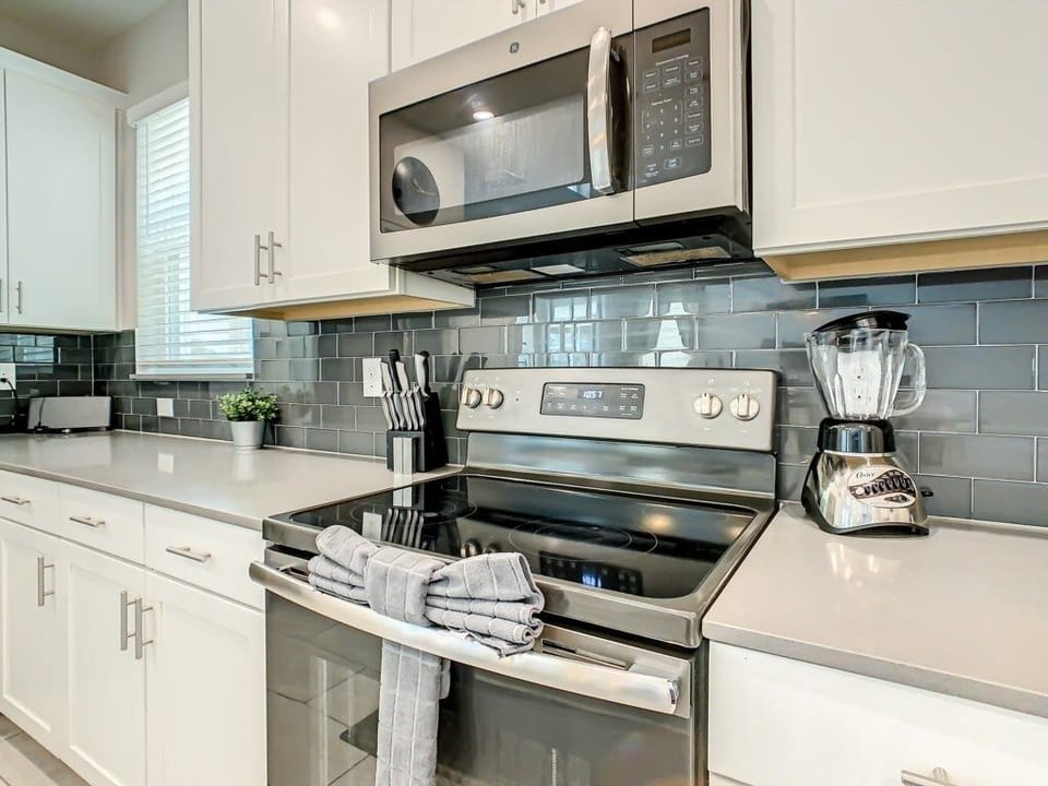 Stainless steel appliances and a contemporary backsplash for a polished touch.
