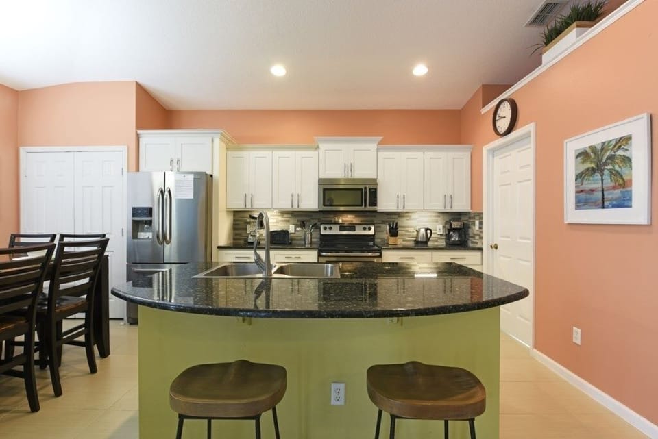 Fully equipped kitchen with modern appliances and a sleek breakfast bar.