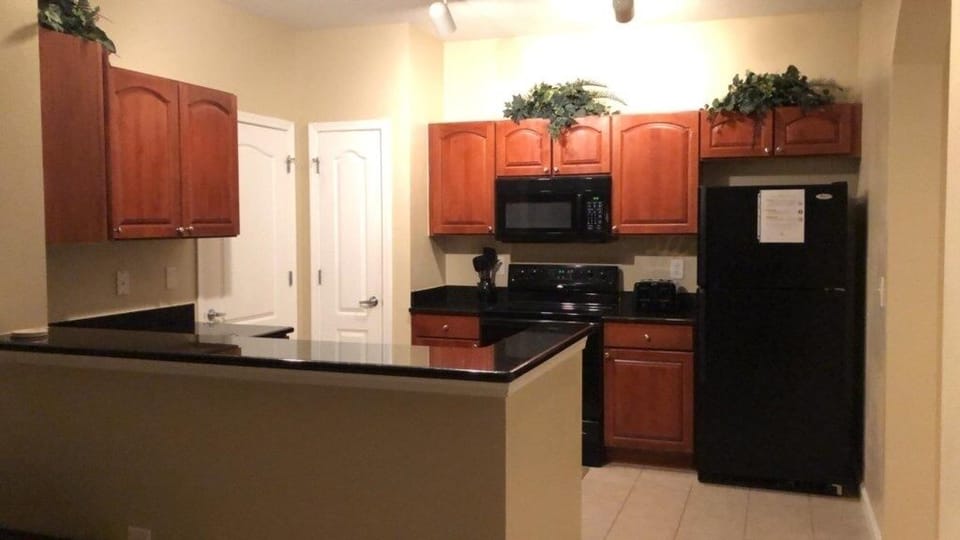 Fully equipped kitchen with modern appliances and ample counter space for cooking.