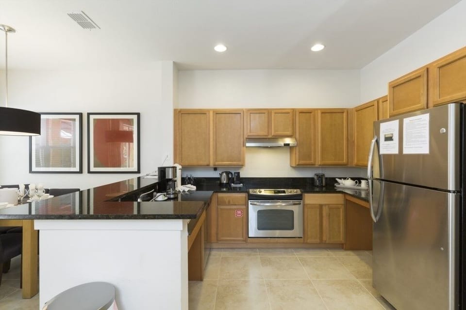 Fully equipped kitchen with modern appliances and ample counter space for cooking.