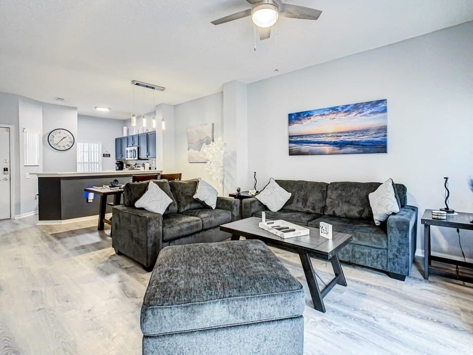 Spacious living room with plush seating and tasteful artwork, ideal for relaxation.
