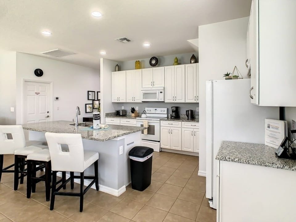 Bright and inviting kitchen with a breakfast bar and seating for casual meals.