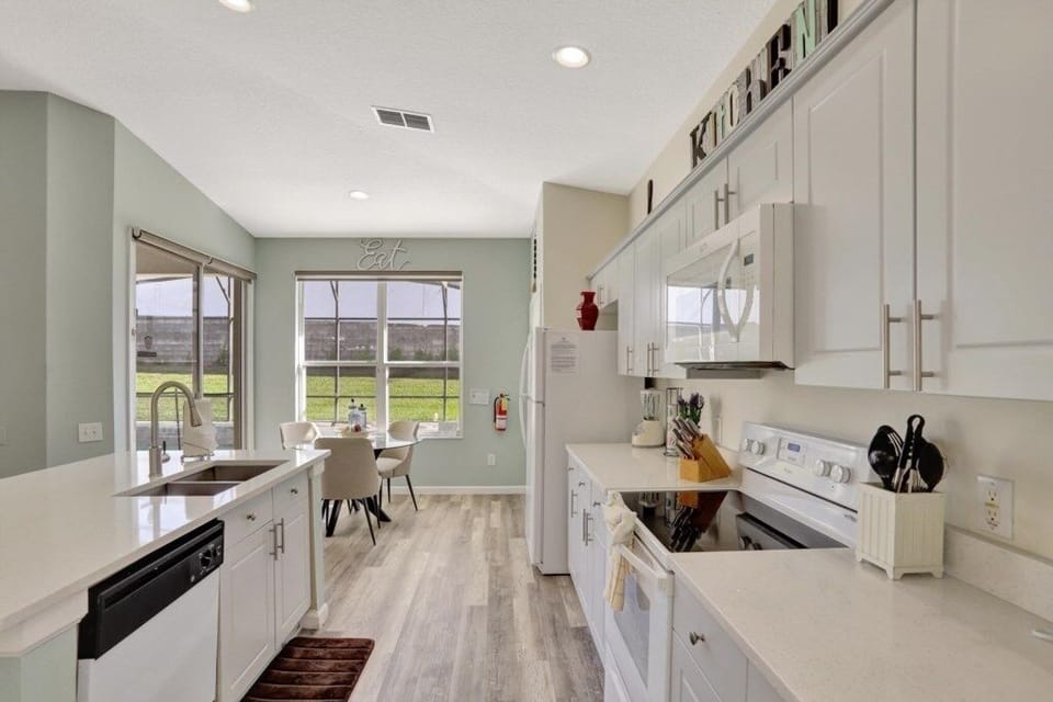 Well-lit kitchen with a functional layout and a view of the dining area.