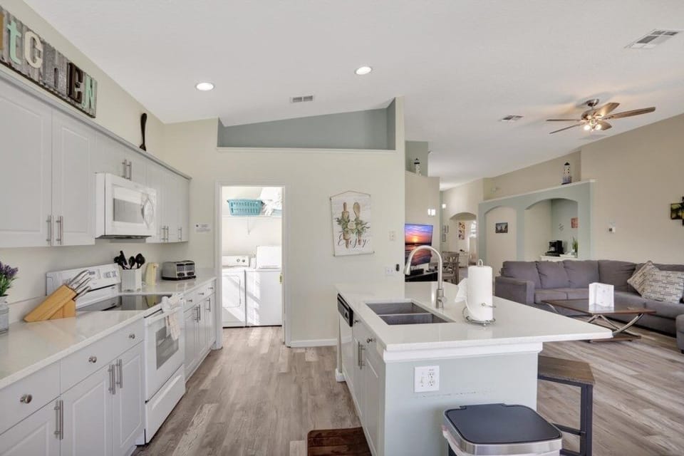 Spacious open-concept kitchen overlooking the living and dining areas.