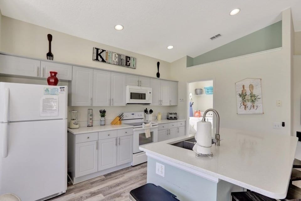Bright and fully equipped kitchen with ample counter space and stylish decor.