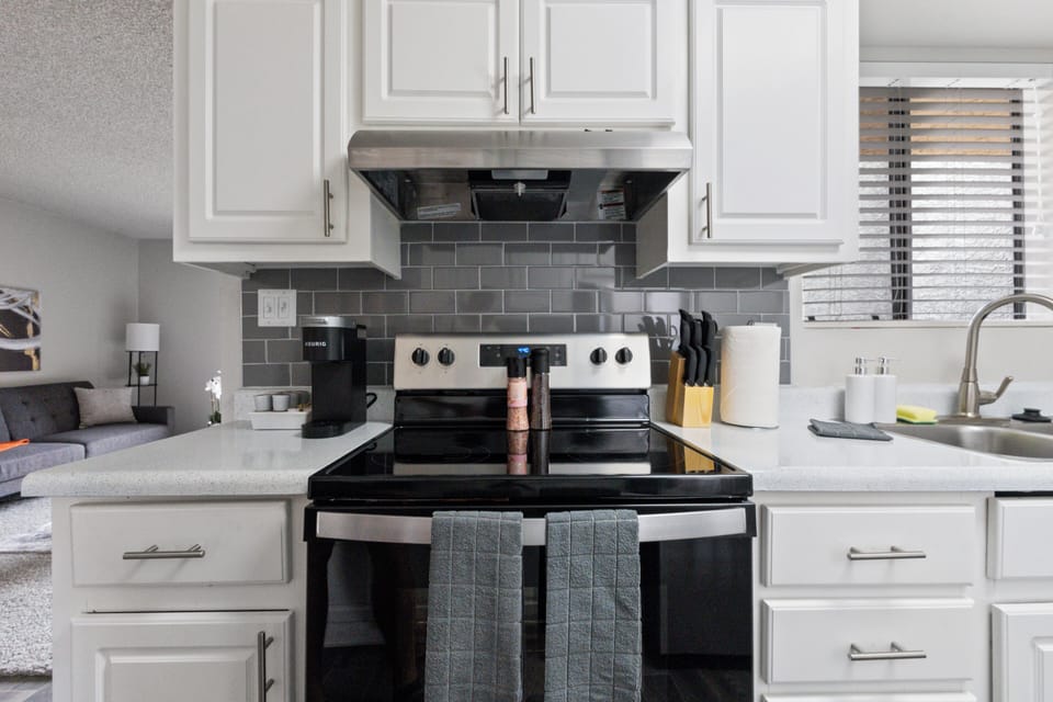 Fully equipped kitchen with stainless steel appliances.