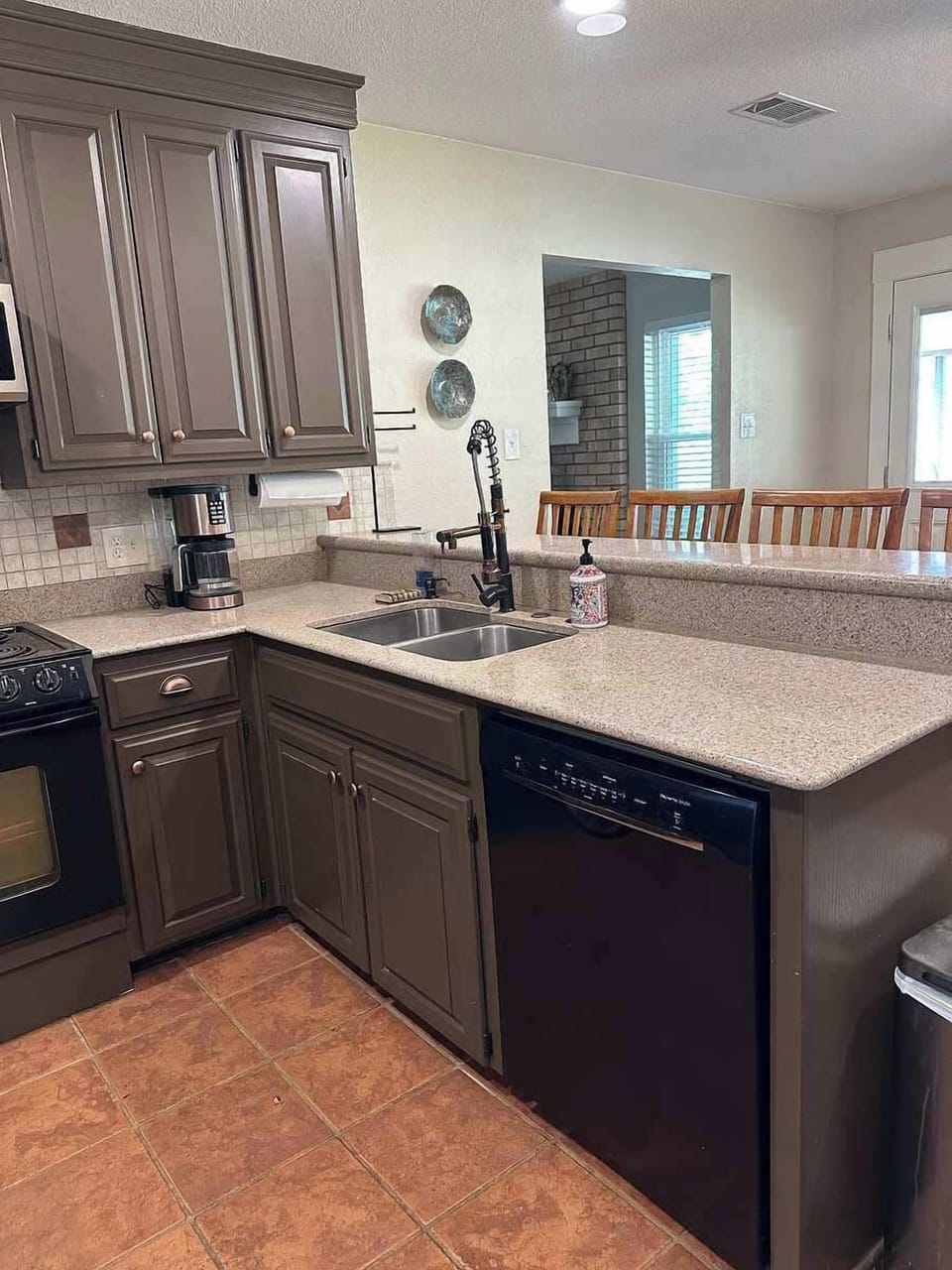 Well appointed kitchen with granite counters and breakfast bar