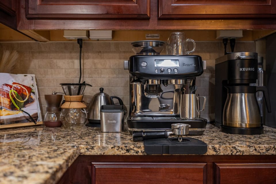 Enjoy your morning brew with our Breville espresso machine and K-Cup coffee maker — perfect for coffee lovers.