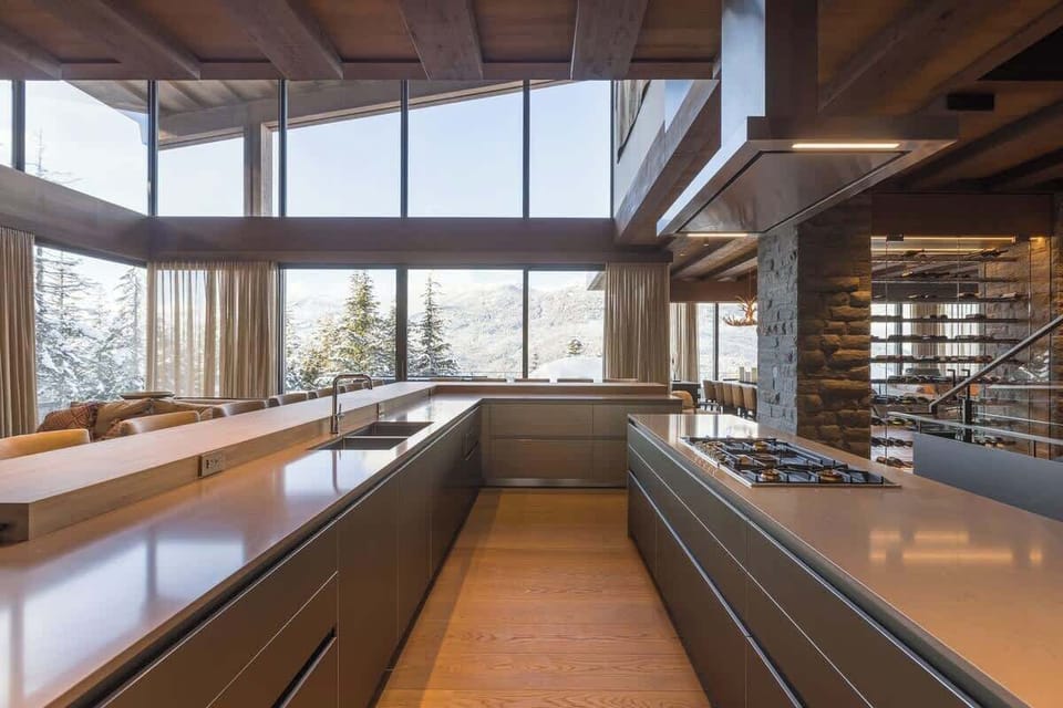 - Modern kitchen overlooking snowy peaks through panoramic glass  
- Bright open counters designed for scenic meal preparation  
- Stunning mountain views enhance every cooking moment  
